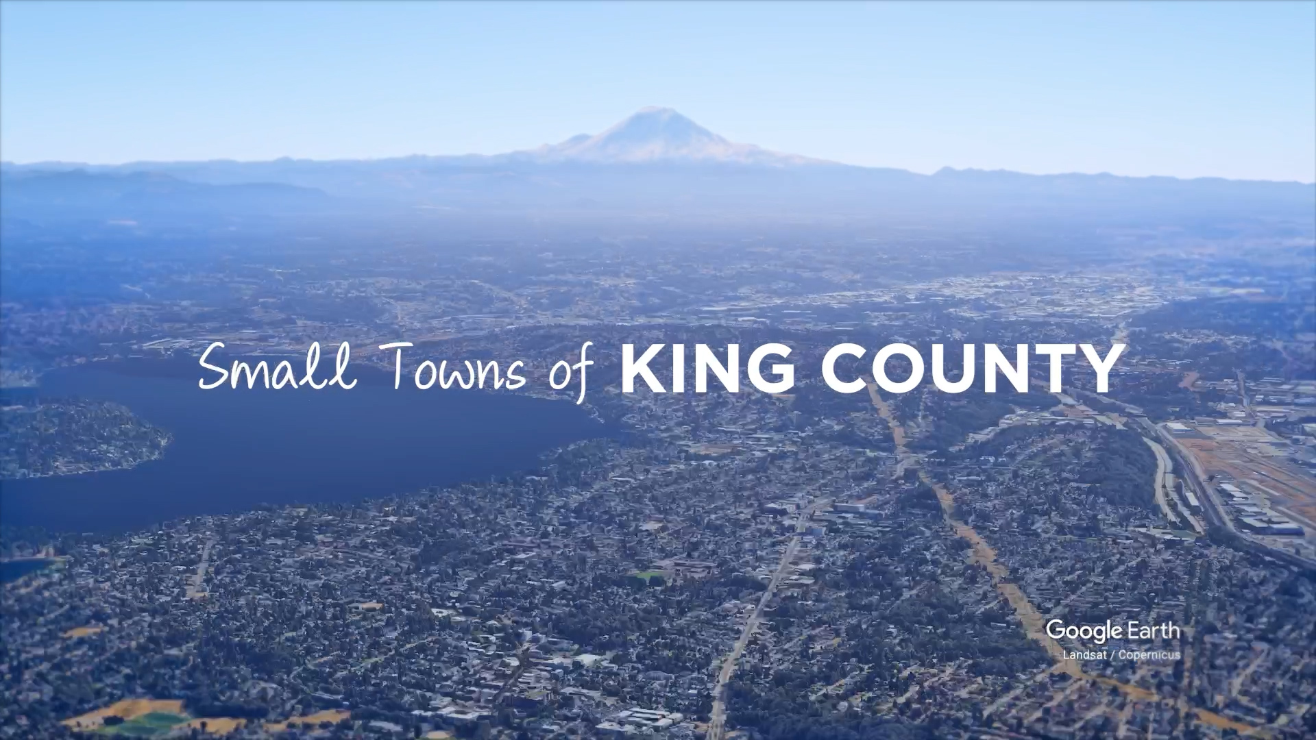 Wide shot of King County with Mt. Rainier in the background. Text says